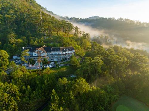 an aerial view of a house in the middle of a forest at Swiss-Belresort Tuyen Lam in Da Lat