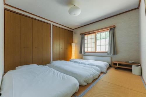 En eller flere senge i et værelse på 森のボヌール