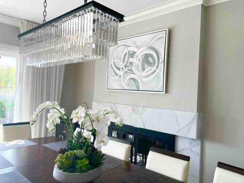 a dining room with a table and a chandelier at Disneyland Paradise 6 BedRoom 4 Bathroom Pool Spa Games in Anaheim