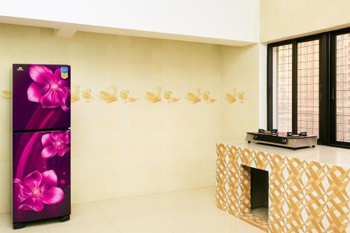 a room with a fireplace and flowers on the wall at Dhaka Furnished Apartment in Gulshan in Dhaka