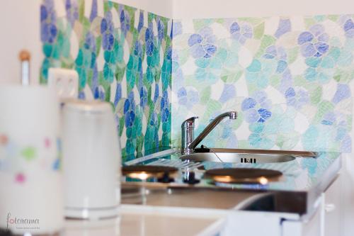 a kitchen counter with a sink and a counter top at George Apartment in Zagreb