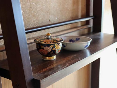 a bowl and a bowl on a wooden counter at Nagahama - House - Vacation STAY 18509 in Nagahama