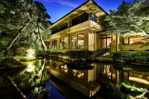 a house with a pond in front of it at moksa in Kyoto