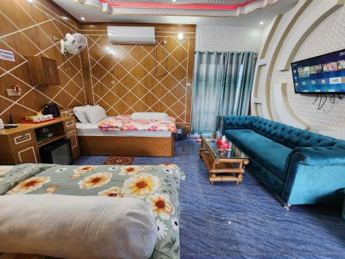 a hotel room with a couch and a bed at Mukta Nagar Resort in Pitua
