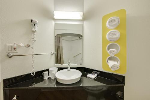 a bathroom with a sink and a mirror at Motel 6-Brampton, ON - Toronto in Brampton