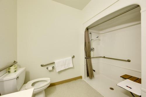 a bathroom with a toilet and a shower at Motel 6-Brampton, ON - Toronto in Brampton