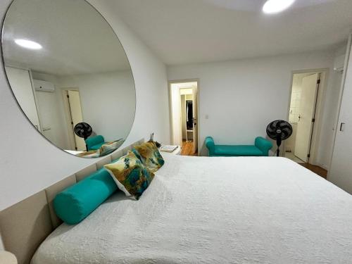 a bedroom with a large bed and a mirror at Casa Moderna com piscina e churrasqueira in Rio de Janeiro