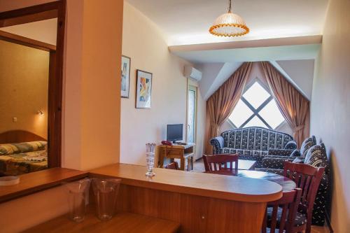 a living room with a table and a couch at Hotel Kristel Park - All Inclusive Light in Kranevo