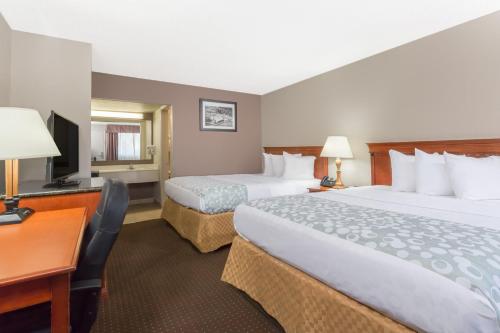 a hotel room with two beds and a desk at Days Inn by Wyndham St Augustine/Historic Downtown in Saint Augustine
