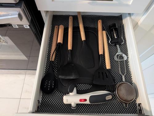 a drawer filled with cooking utensils in a kitchen at Modern 3BR Home Near Niagara Falls & Welland Canal in Welland