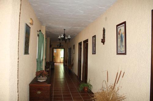 a hallway of a house with a tile floor at Hotel Restaurante Atalaya in Comares