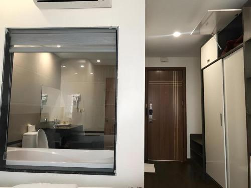 a bathroom with a large mirror in a room at Smart Hotel in Bắc Ninh