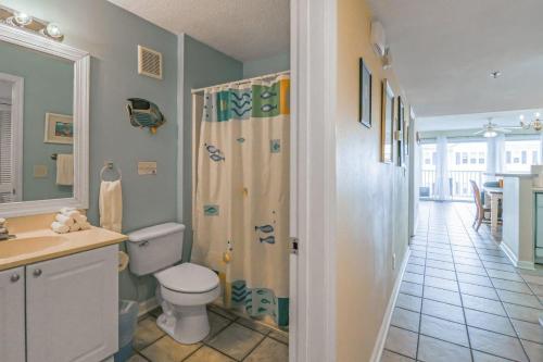 a bathroom with a toilet and a shower in it at Tybee Summer Winds 523 Condo in Tybee Island