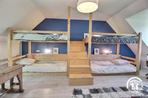 two bunk beds in a room with a blue wall at Ker wan in Plérin