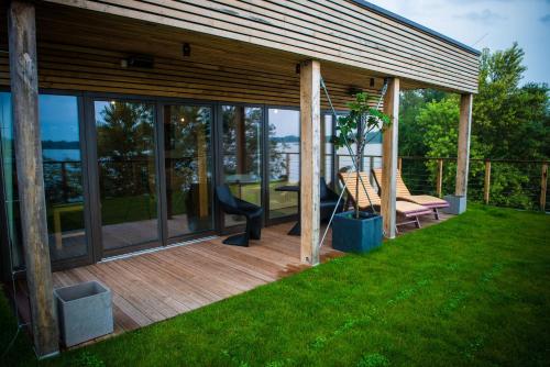 a house with a deck with a swing at Zagreb Camp Bungalows in Rakitje