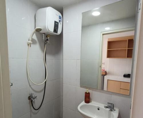a bathroom with a shower and a sink at Delft Apartment CPI in Tanjungbunga