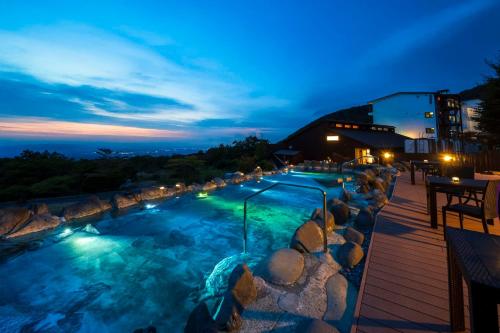 a swimming pool at night with a view at YU-FURI Nasu-Takao Onsen Lodge in Nasu
