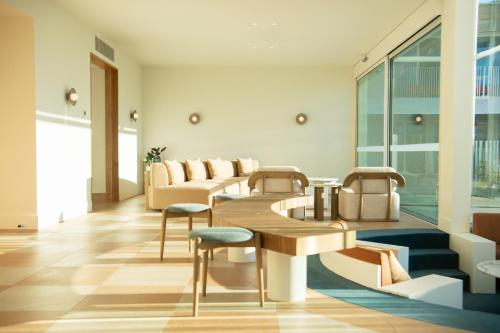 a lobby with tables and chairs in a building at Kar-Rama Hotel in Mildura