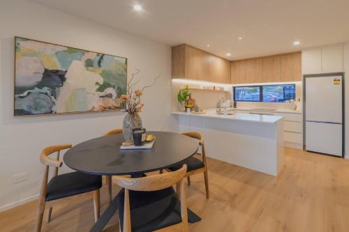 a kitchen and dining room with a table and chairs at Charming Getaway on Gloucester Street in Linwood