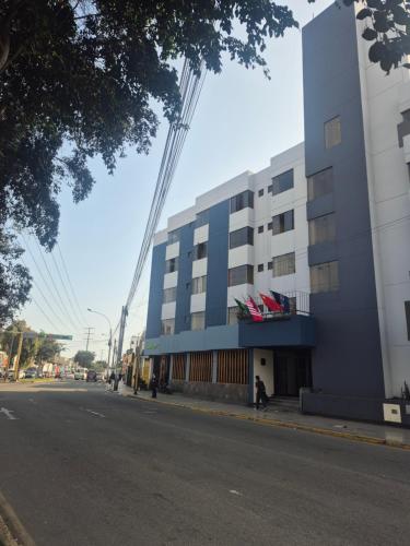 a blue building on the side of a street at Hotel Naciones Unidas in Lima
