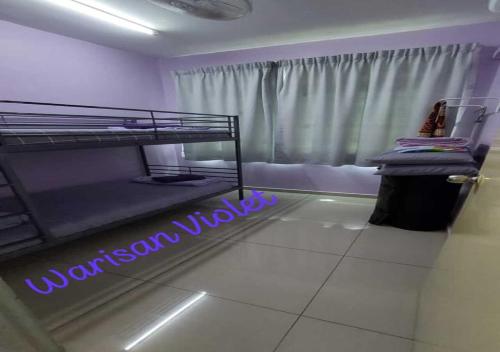 a bedroom with a bunk bed with a neon sign at Homestay Warisan Violet Tg Minyak in Malacca