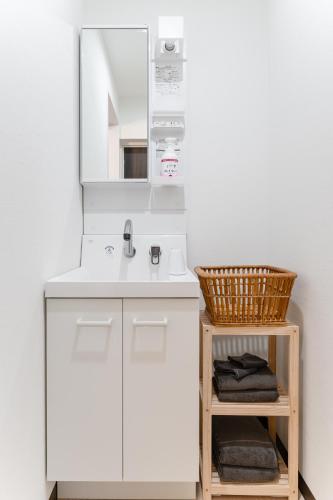 a bathroom with a sink and a mirror at Planetarium N in Yamashitachō
