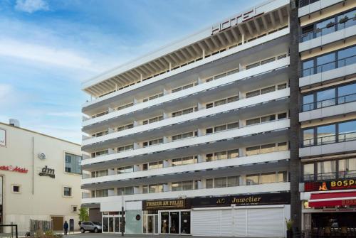 a large building with a parking garage in front of it at Aspire Palais Recklinghausen, Trademark Collection by Wyndham in Recklinghausen