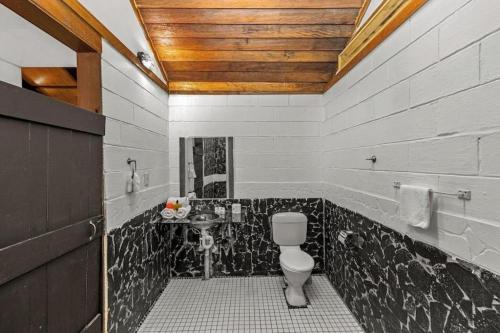 a bathroom with a toilet and a sink at Orator Hotel in Apia