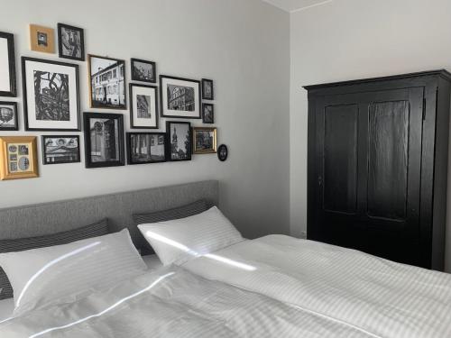 a bedroom with a bed with pictures on the wall at Maison baroque in Blieskastel