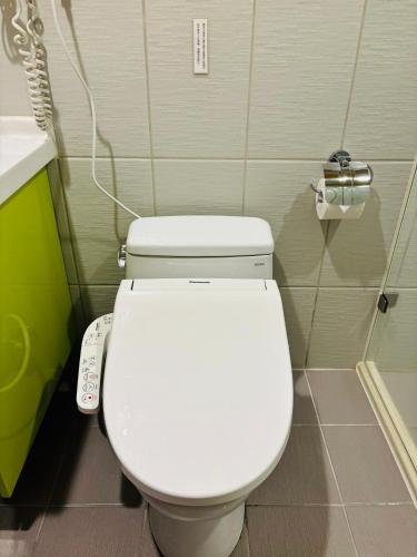 a bathroom with a white toilet in a room at Starburst Bed & Breakfast宜蘭羅東星賞民宿 in Dongshan