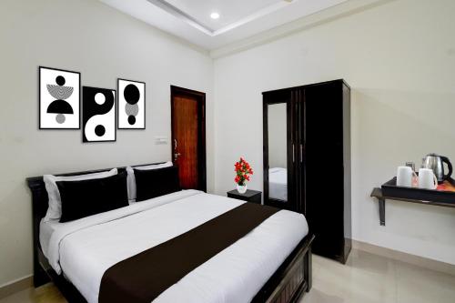 a bedroom with a bed with black and white at Collection O Adibatla X Road, Near TCS, Wonderla Road in Ibrāhīmpatan