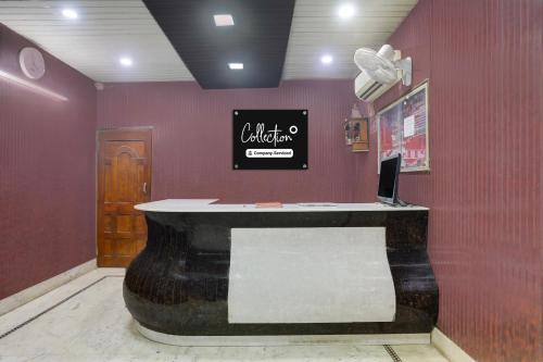 a salon with a counter in a room with purple walls at Collection O Chhapra Railway Junction Formerly Hotel City Palace in Chupra