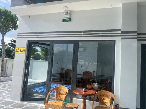 a patio with a table and chairs on a building at Nhà Nghỉ Phát Thành in Trà Vinh