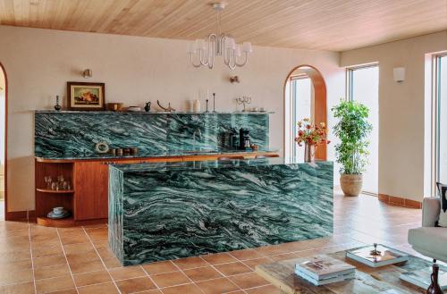 a living room with a large marble fireplace at Buenadumo Jeju Tennis Holiday Villa in Sinch'ang-ni