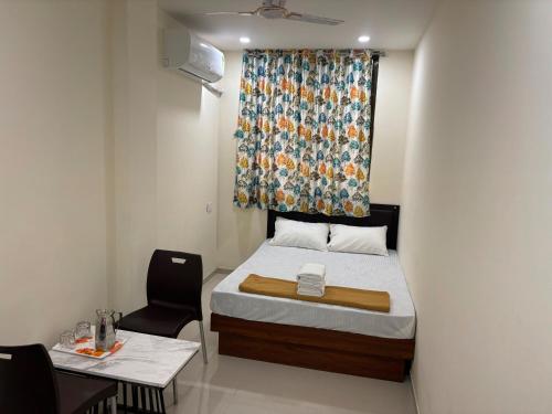 Un dormitorio pequeño con una cama y una ventana. en Hotel O Elegance Inn, en Sopāra