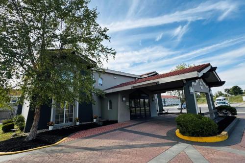 an entrance to a building with a garage at Baymont by Wyndham Indianapolis Airport Lynhurst in Indianapolis