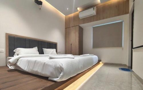 ein Schlafzimmer mit einem großen weißen Bett und einem Fenster in der Unterkunft Townhouse Svb Tech Park Kalapatti Formerly RG Stays in Coimbatore (Peelamedu)