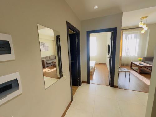 a living room with two mirrors on the wall at Orange apartments in Yerevan