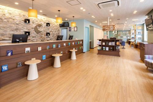 a lobby of a store with tables and a counter at Comfort Hotel Niigata in Niigata