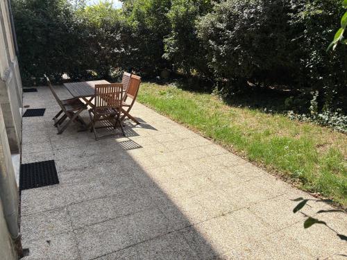 two chairs and a table on a patio at Le Clos - Centre ville - Jardin - Parking privé in Poitiers