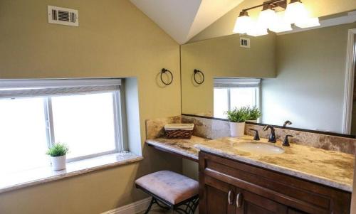 a bathroom with a sink and a large mirror at Destination #08 in Anaheim