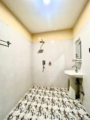 a bathroom with a sink and a toilet at Hotel Happy Land in Chitwan