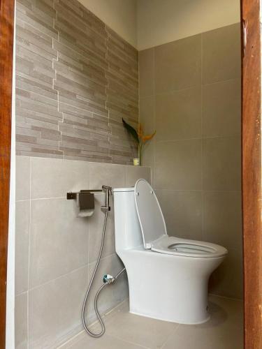 a bathroom with a toilet with a water hose at Kwainoy Riverpark in Sai Yok