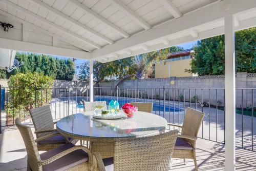 a patio with a table and chairs and a pool at Destination #44 in Orange