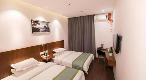 a hotel room with two beds and a television at Vatica Shanghai Jiading District Anting Metro Station Moyu Road Hotel in Shanghai