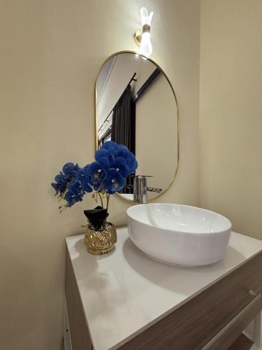 a bathroom with a white sink and a mirror at Lora House in Sukoharjo