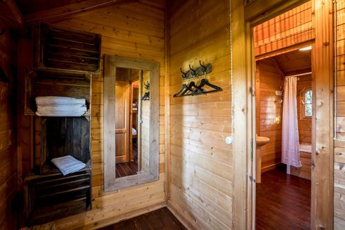 a wooden cabin with a hallway and a mirror at Estança La Pau - Adults Only in Mallá