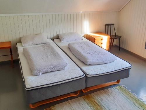 two twin beds in a room with a table at 8 person holiday home in Åfarnes-By Traum in Årset
