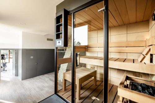 a sauna in a house with a glass door at Estança La Pau - Adults Only in Mallá