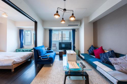 a living room with a blue couch and a table at AROMA in Sapporo